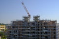 Skyscraper in construction close-up with a crane. Building construction site. Construction works Royalty Free Stock Photo