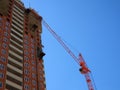 Russia, Saratov - may, 2020: Skyscraper construction. Construction site background. Self-erecting crane with cargo near the Royalty Free Stock Photo