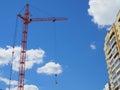 Russia, Saratov - may, 2020: Skyscraper construction. Construction site background. Self-erecting crane with cargo near the Royalty Free Stock Photo