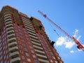 Russia, Saratov - may, 2020: Skyscraper construction. Construction site background. Self-erecting crane with cargo near the Royalty Free Stock Photo