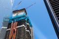 Skyscraper construction with crane on the roof. Royalty Free Stock Photo