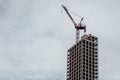 Skyscraper construction site with crane against cloudy sky, New York City, USA Royalty Free Stock Photo