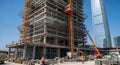 Skyscraper construction site with cranes and workers under a clear blue sky building architecture Royalty Free Stock Photo