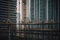 Skyscraper construction site in a major city, steel beams reaching for the sky, workers in hardhats and safety vests, and the Royalty Free Stock Photo