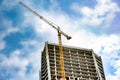 Skyscraper construction. Tower crane over construction building.