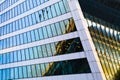 Skyscraper exterior design. Abstract view of window, mirror reflection and detail architecture close-up. Modern office building. Royalty Free Stock Photo