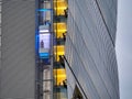 Skyscraper external elevator with persons silhouette inside