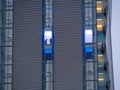 Skyscraper external elevator with persons silhouette inside