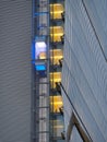 Skyscraper external elevator with persons silhouette inside