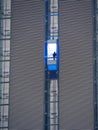 Skyscraper external elevator with persons silhouette inside