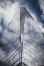 Skyscraper with glass facade and clouds reflected in windows Royalty Free Stock Photo
