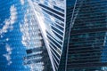 Skyscraper glass facades on a bright sunny day with sunbeams in the blue sky. Economy, finances, business activity concept. Bottom Royalty Free Stock Photo