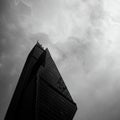Skyscraper with a modern, angular design, featuring sharp, geometric lines and a Royalty Free Stock Photo