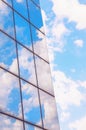 A skyscraper or modern building in a city with clouds and sunlight reflected in the Windows Royalty Free Stock Photo