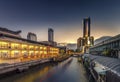 Skyscraper and Pratunam pier in Bangkok; water transportation by