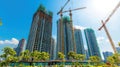 Skyscraper under construction with cranes and scaffolding against a clear Royalty Free Stock Photo