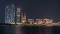 Skyscrapers of Abu Dhabi at night with Etihad Towers buildings . Royalty Free Stock Photo