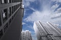 Skyscrapers on a background of blue sky with white clouds Royalty Free Stock Photo