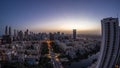 Skyscrapers in Barsha Heights district and low rise buildings in Greens district aerial night to day timelapse.