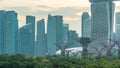 Skyscrapers behind Gardens by the bay with supertrees day to night timelapse after sunset Royalty Free Stock Photo