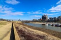 Skyscrapers and buildings in the city skyline along the water in Wolf Creek Harbor with red and white steam boats docked Royalty Free Stock Photo