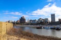 Skyscrapers and buildings in the city skyline along the water in Wolf Creek Harbor with red and white steam boats docked Royalty Free Stock Photo