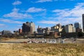 Skyscrapers and buildings in the city skyline along the water in Wolf Creek Harbor with red and white steam boats docked Royalty Free Stock Photo