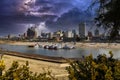 Skyscrapers and buildings in the city skyline along the water in Wolf Creek Harbor with red and white steam boats docked Royalty Free Stock Photo