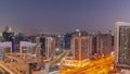 Skyscrapers at the Business Bay in Dubai aerial day to night timelapse, United Arab Emirates