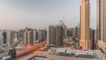 Skyscrapers at the Business Bay in Dubai aerial night to day timelapse, United Arab Emirates