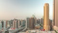 Skyscrapers at the Business Bay in Dubai aerial night to day timelapse, United Arab Emirates