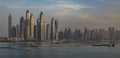 Skyscrapers of Dubai Marina at sunset, with the sun glinting of the glass of the modern buildings. Royalty Free Stock Photo