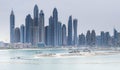 Skyscrapers of Dubai Marina at sunset, with the sun glinting of the glass of the modern buildings. Royalty Free Stock Photo