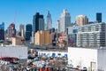 Skyscrapers and Equipment surrounding Trains in a Long Island Rail Road Yard