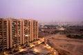 Skyscrapers in gurgaon looking out over barren land and a village Royalty Free Stock Photo