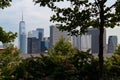 Lower Manhattan Skyline Framed between Green Trees on Governors Island in New York City during Summer Royalty Free Stock Photo