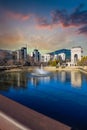 Skyscrapers and office buildings in the skyline of the city with a gorgeous lake with a water fountain in the center