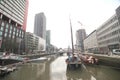 Skyscrapers, old boats and business people around the water of Wijnhaven in the center of Rotterdam