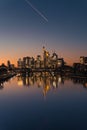 Skyscrapers reflecting in the river in the city at sunset, Frankfurt, Germany