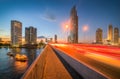 Skyscrapers and Traffic Light Trails on a Bridge Crossing a River Royalty Free Stock Photo