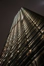 Illuminated Skyscraper at night looking up from below