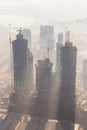 Skyscrappers construction site with cranes on top of buildings. Royalty Free Stock Photo