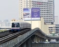 Skytrain BTS passing on an elevated level above the road in Bangkok, Thailand