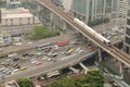 Skytrain is moving on rails at road junction.