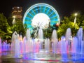 Skyview Atlanta Ferris Wheel in motion and Centennial Olympic Park Fountain. Atlanta, GA. Royalty Free Stock Photo