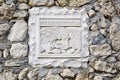 Slab with an ancient carved relief depicting a hunting lion, embedded in a stone fence of Assumption Monastery in Bakhchisarai,