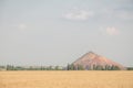 Slagheap in western Ukraine with wheat field Royalty Free Stock Photo