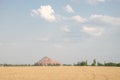 Slagheap in western Ukraine with wheat field Royalty Free Stock Photo