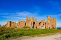 Slains Castle East wall in sunny day and blue sky zoom out Royalty Free Stock Photo