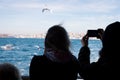 Sland Ferry Ada Vapuru. Some of the ferry passengers feed seagulls. Passenger ferryboats from Istanbul sail regularly to the Pri